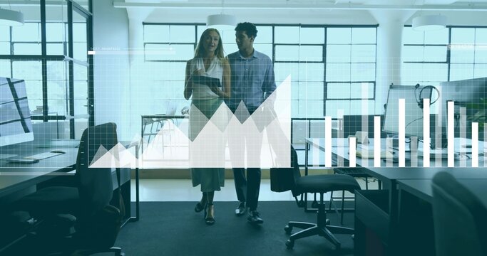 Walking colleagues navigating open office in business wear, holding tablet with data graph overlay - Powered by Adobe