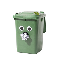 A green bin with googly eyes and crumpled paper in its opening adorned with a leaf