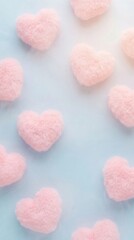 Fototapeta premium Soft pink hearts scattered on a serene blue backdrop, creating a gentle and loving atmosphere. The hearts are fluffy and delicate, adding a touch of tenderness to the scene. 
