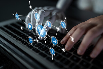 A robotic hand interacts with digital icons on a laptop keyboard, symbolizing advancements in technology and automation. This image captures the essence of innovation. Tessel