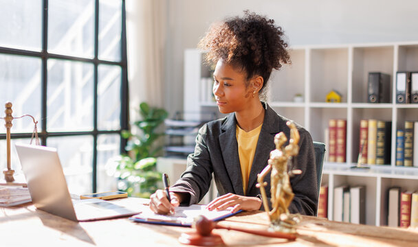 African American Lawyer woman afro hair working at office desk, concepts of law and legal services, law contract.
