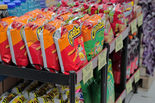Shelves stocked with Cheetos bags in a grocery store in Lombok, Indonesia, 14 July 2025