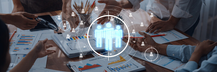 Team members engage in a collaborative meeting with digital tools. The image showcases hands working together, highlighting teamwork and communication in a business environment. Trope