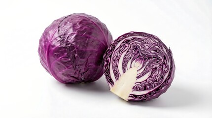 Obraz premium A detailed studio shot showcases two red cabbages one whole and one halved against a clean white background highlighting their vibrant color and