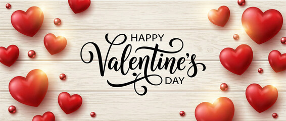 Happy Valentine's Day calligraphy on a light wooden background adorned with glossy red hearts and small decorative beads, celebrating love and romance.