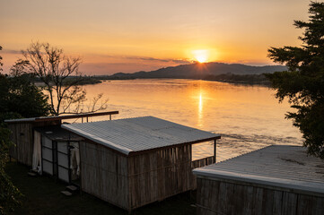Beautiful sunset behind the mountain look through the Mekong river at the border between Thailand and Laos. Mekong River, the longest river in Southeast Asia, 7th longest in Asia.