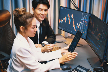 Businesswoman holding tablet on dynamic stock exchange statistic online showing to partners to...