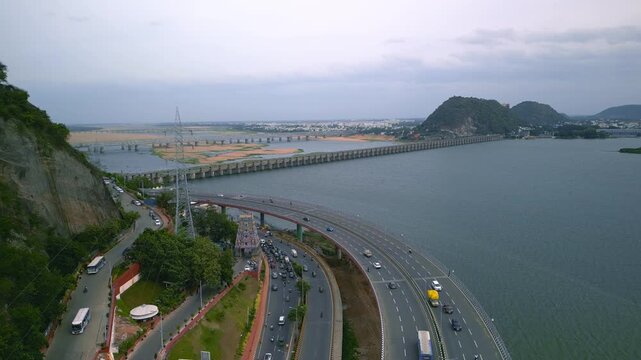 Aerial panoramic view of historic Prakasam barrage and newly constructed Kanaka Durga varadhi (bridge) on the Krishna river at Vijayawada, India