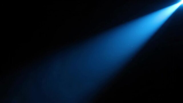 Blue Spotlight Beam Illuminating Dark Space with Subtle Dust Particles.