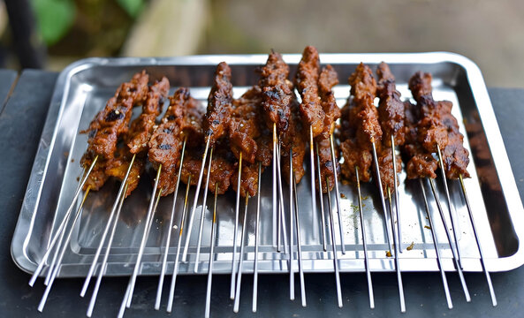 Sate Klatak Bantul, Indonesian Grilled Mutton Skewers on Metal Spokes over a Silver Tray