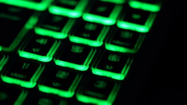 Green backlit numeric keypad with motion blur, representing password entry, PIN code input and digital security. Futuristic technology background.