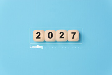 Wooden blocks in loading bar for 2027 Goal planning business concept