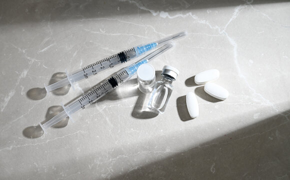 Glass Vials Peptide Compounds and Single Use Syringes Next to Weight Loss Pills