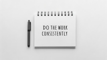 Motivational Notebook with Pen Displaying Work Quote