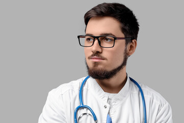 Portrait of handsome doctor in eyeglasses on light background, closeup