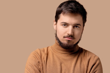 Obraz premium Portrait of handsome bearded man on beige background, closeup