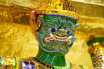 Colorful Guardian Statue Adorned with Gold and Intricate Patterns