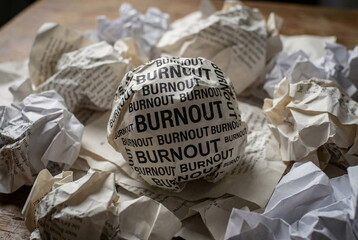 Workplace burnout concept showing repeated stress fatigue mental exhaustion and productivity pressure through crumpled paper notes.