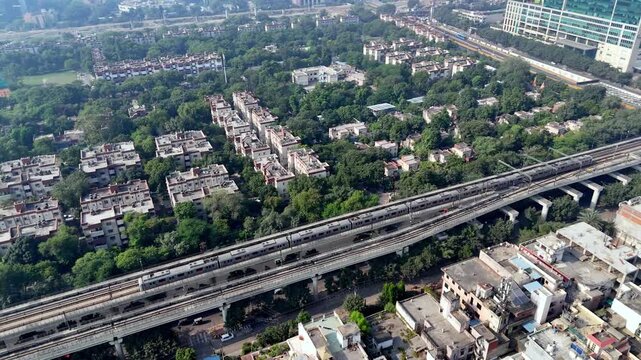 Drone shot of Noida Sector 16 in the morning, highlighting metro infrastructure, leafy neighborhoods, and quiet streets before peak urban activity starts.
