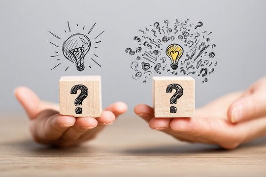 Wooden blocks with question marks & lightbulb doodles, held in open palms, showing contrasting ideas