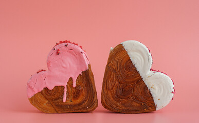 Delicious fresh croissant topped with colorful flavor Ganache. Creation unique heart shape bakery. Puff pastry holiday love gift present idea Valentine's day. Copy space 