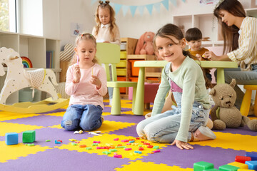 Cute little girls playing in kindergarten