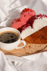 Morning breakfast coffee wooden tray bed rumpled bedding Valentine's Day Birthday celebration Delicious fresh variety croissants topped with colorful flavor Ganache. Creation unique heart shape bakery