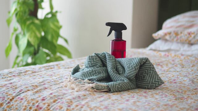 Cleaning a bed with fabric spray and a cloth