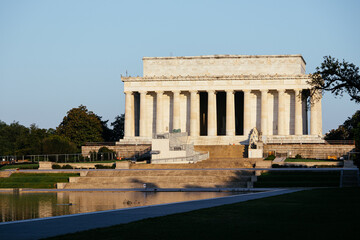 Fototapeta premium Lincoln Memorial at sunrise reflecting in the water, Washington DC historic monument view. c.