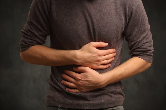 A person developing gastrointestinal issues like irritable bowel syndrome (IBS).