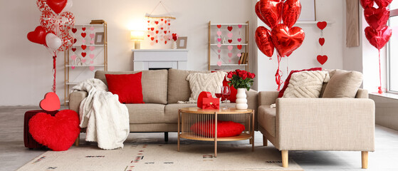 Interior of festive living room with grey sofas, roses and heart-shaped balloons. Valentine's Day...