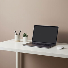 Modern workspace with laptop and plants on white desk