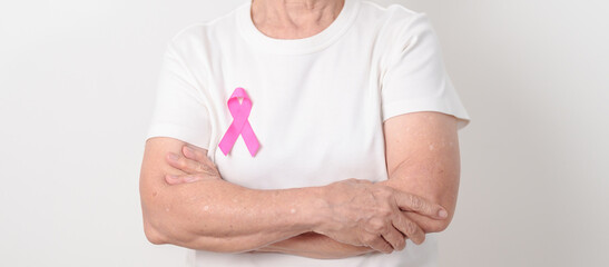 Elderly woman with pink Ribbon for Pink October Breast Cancer Awareness month, May Women Health, February World cancer day, support people life and illness. National cancer survivors month