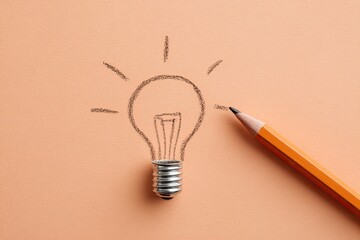 A drawn lightbulb with a pencil resting beside it, on a peach colored background