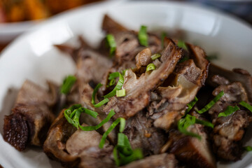 Thai Style Grilled Pork Neck On Ceramic Dish.