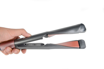 Fototapeta premium One hand holding a straightening iron