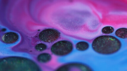 Ink stains. Oil droplet. Defocused pink blue colorful sparkling water marble wet round liquid on abstract art chemical background.