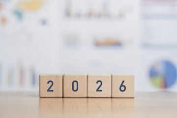 2026 text on wooden block with icons. Goals. New Year 2026 concept. Beginning of success. Business investment goals for the coming year.