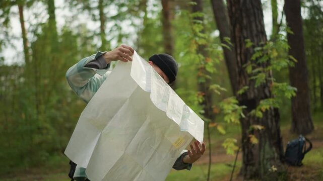 Happy explorer finds way, Young hiker confidently navigates forest trail, Confident young traveler discovers new pathway through woods, Joyful novice trekker uncovers her intended course in forest