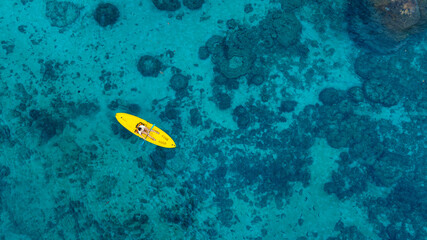 Aerial view of a kayak in the blue sea .man kayaking he does water sports activities.	
