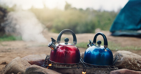 Camping, steam and kettle on campfire outdoor for boiling water, hot beverage and travel efficiency. Holiday adventure, fire and pots with vapor in nature for cooking process and weekend vacation