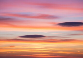 Vibrant pink and orange sunset sky with soft wispy clouds creating a serene and calming atmosphere