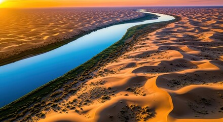 Serpentine watercourse cuts through expansive, sunlit desert dunes from a high aerial perspective