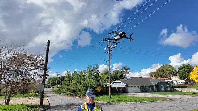 A Contractor Using a Drone to Inspect a Road