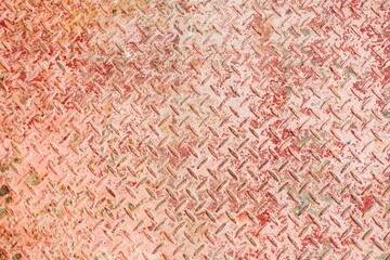 Rusty diamond plate metal surface with worn paint and rough texture, industrial background showing corrosion, durability, and heavy-duty material detail.