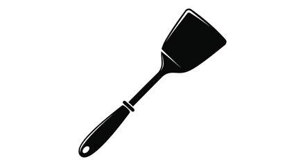 A stark black spatula against a white backdrop creating a dramatic kitchen tool silhouette