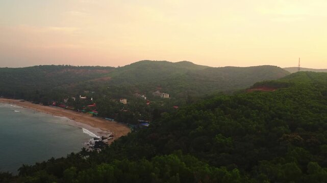 Beautiful sunset over the Arabian Sea, with the sun dipping below the horizon and warm golden light spreading across calm waters.