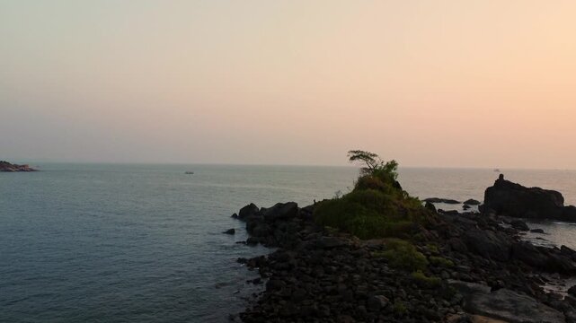 Beautiful sunset over the Arabian Sea, with the sun dipping below the horizon and warm golden light spreading across calm waters.