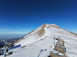 Ski slope with a snow covered mountain in the background