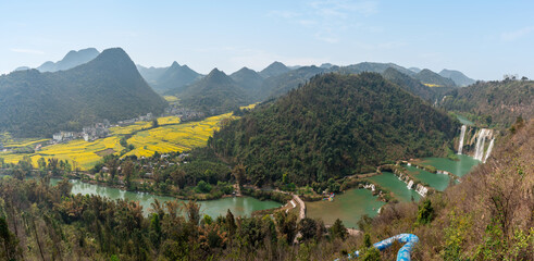 Beautiful scenic landscape of canola fields in spring at Jiulong waterfall in Luoping, China